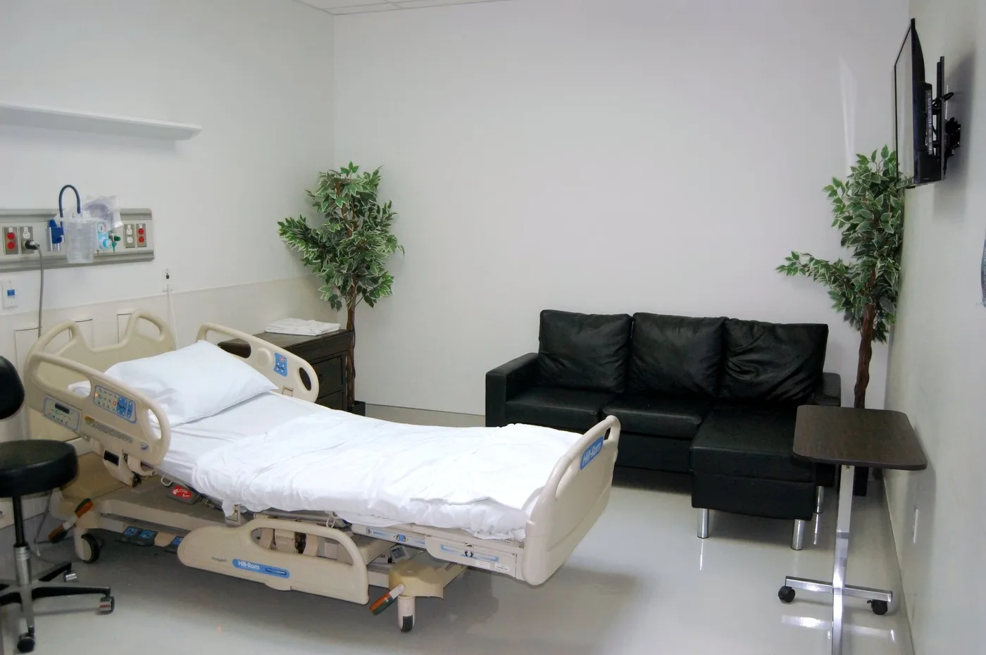 A private patient room with family seating at Fountain Hills Emergency Room.
